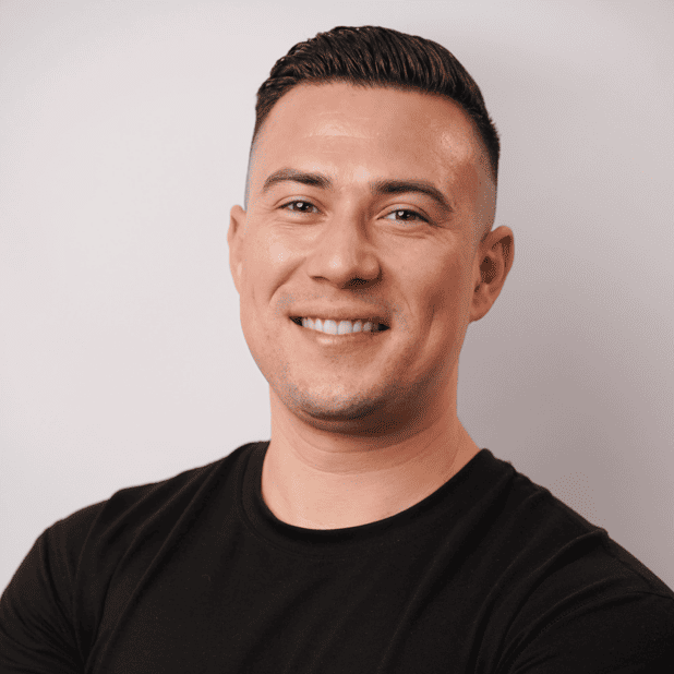 Smiling man in a black shirt, representing successful branding and SEO strategies for health and wellness businesses.