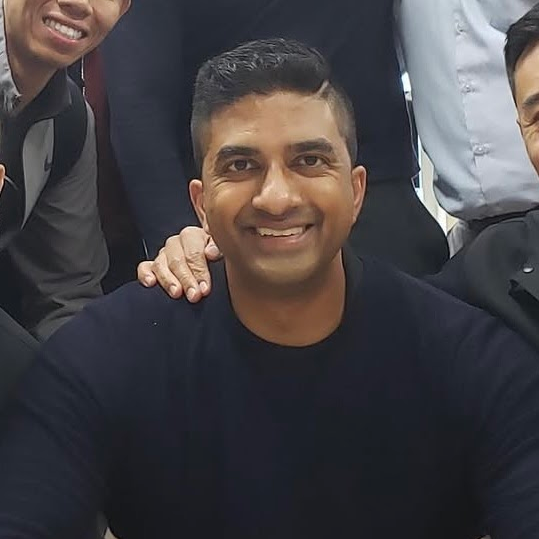 Group of professionals smiling together, highlighting teamwork and collaboration in a business context related to branding and SEO strategies.